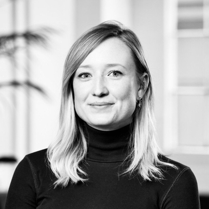 Adyen team member in the office wearing a black turtleneck.