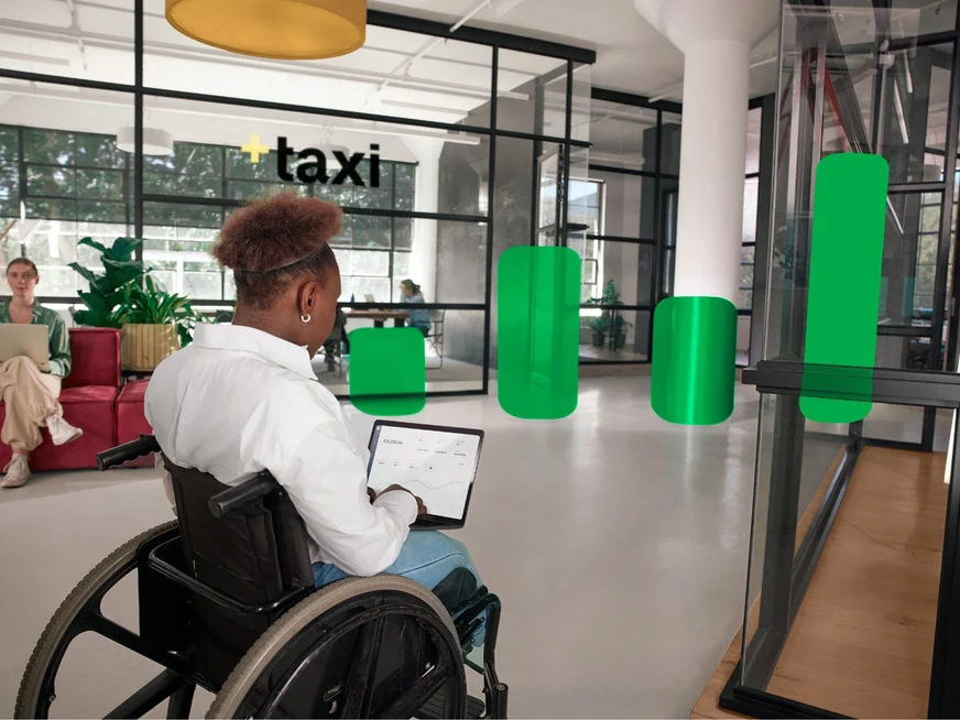 Person typing on laptop with a dashboard screen visible