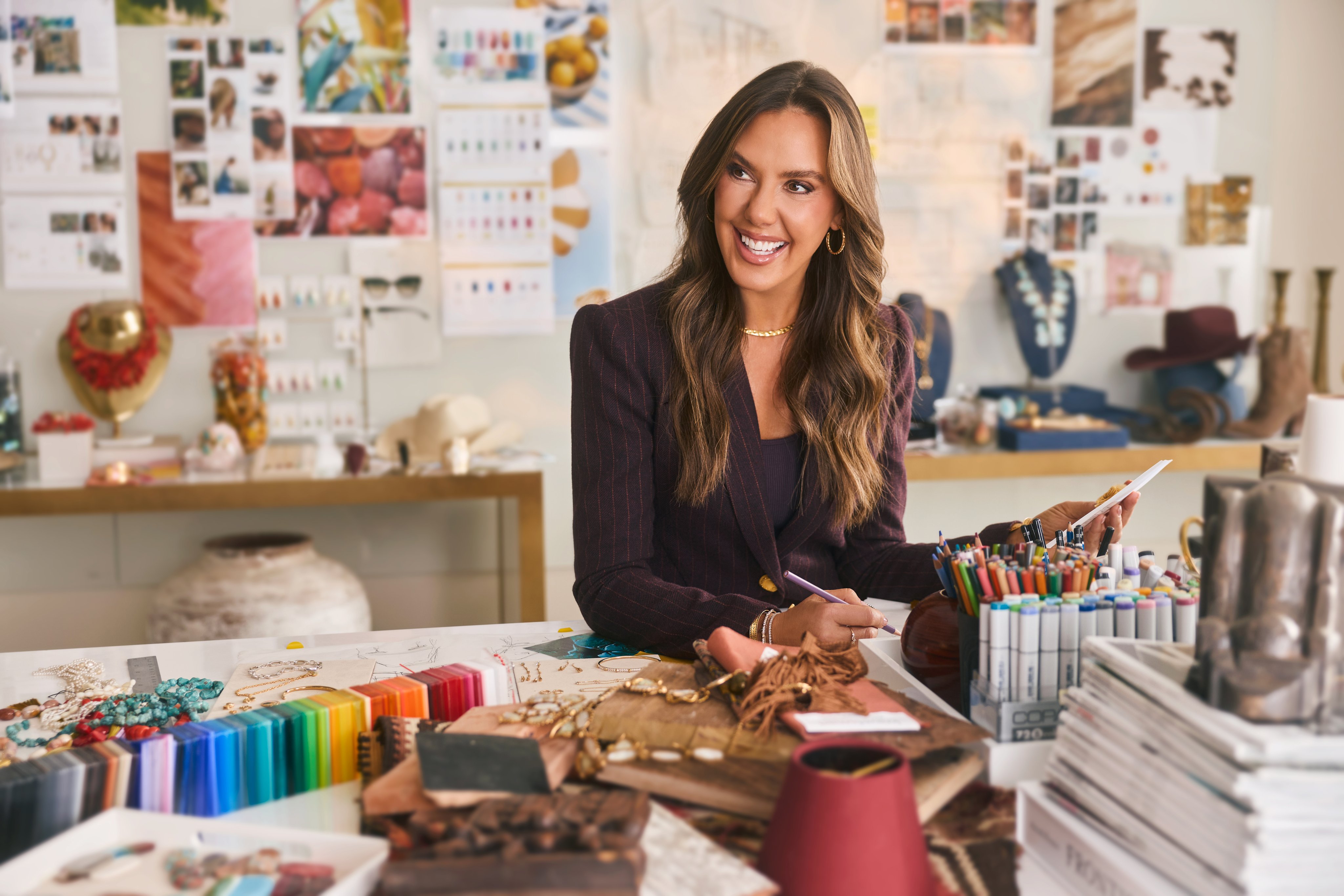 Creative workspace with fabric samples, color swatches, and design tools on a table.