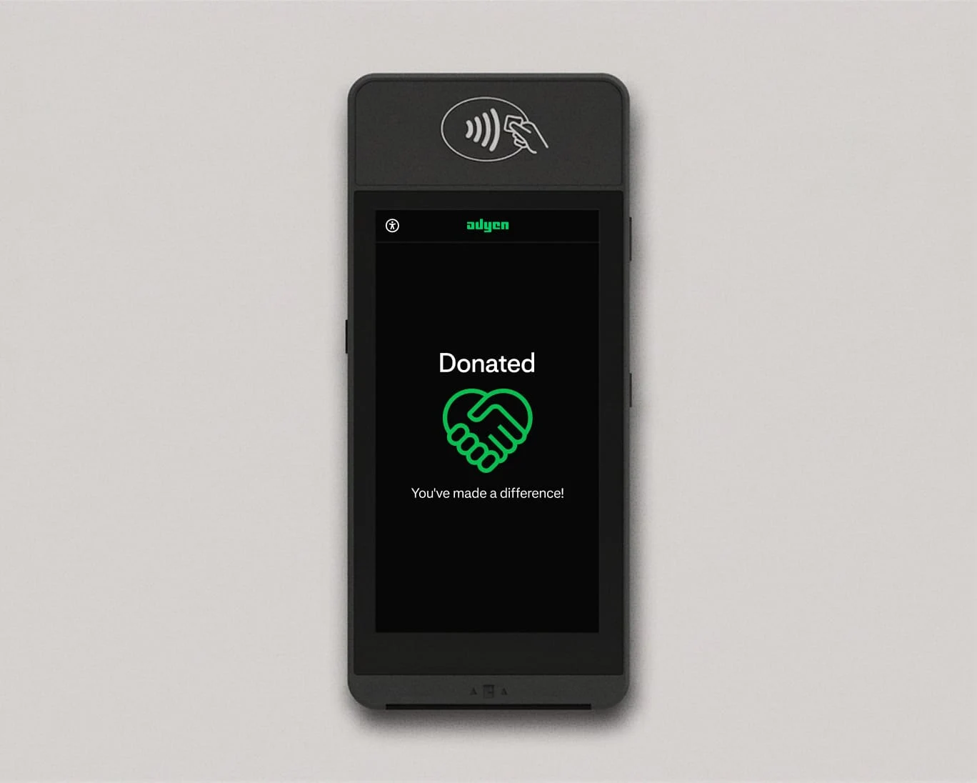 A payment terminal displaying a donation confirmation with Adyen branding and a handshake icon.