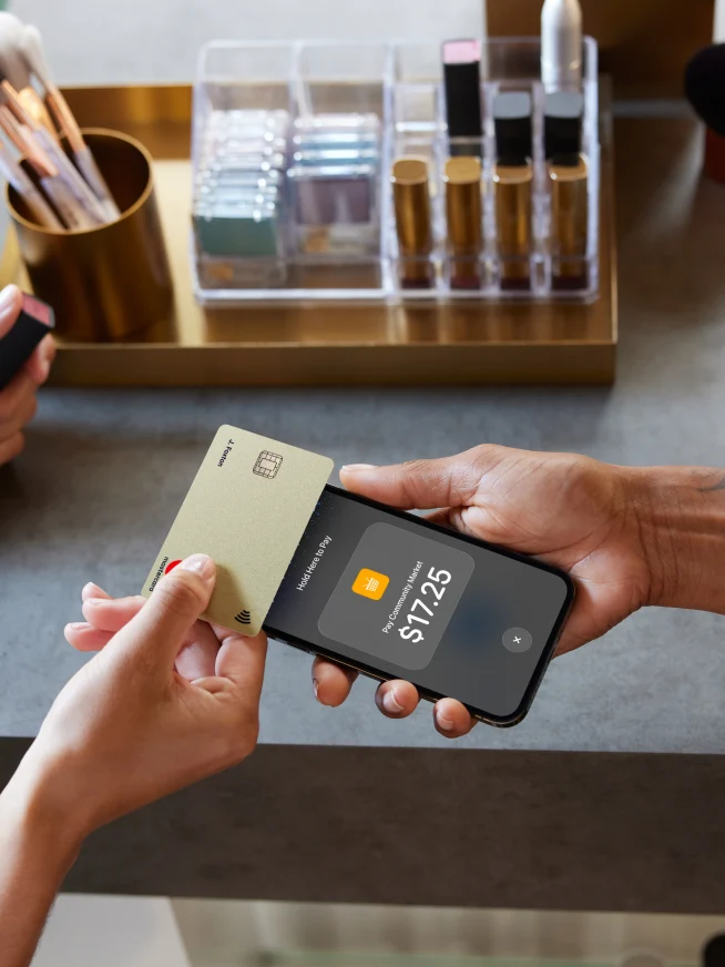 A customer pays with an Adyen card terminal in a modern retail setting.