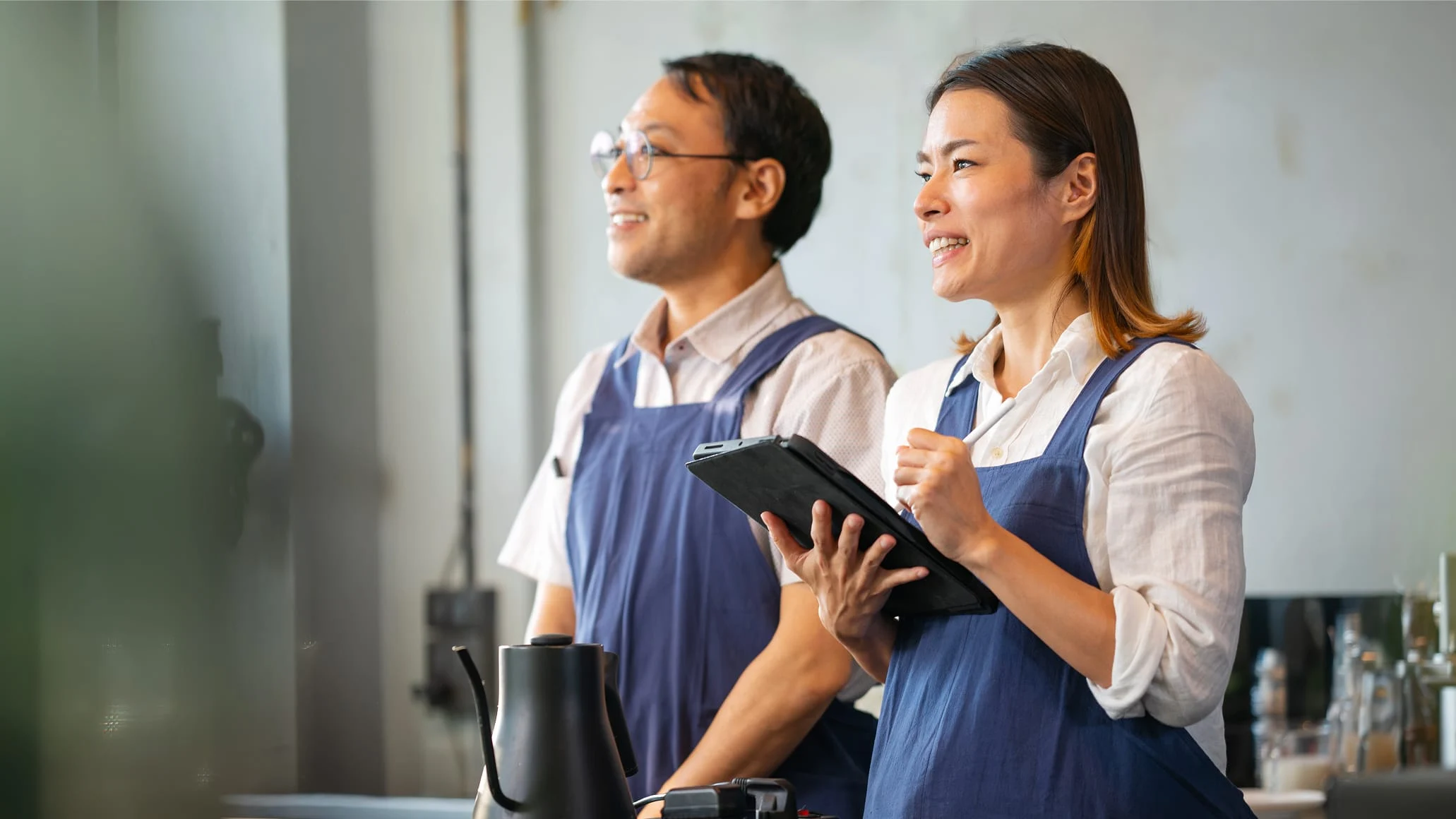 Adyen employees in the Adyen office smiling during a transaction with a payment terminal provided by Adyen