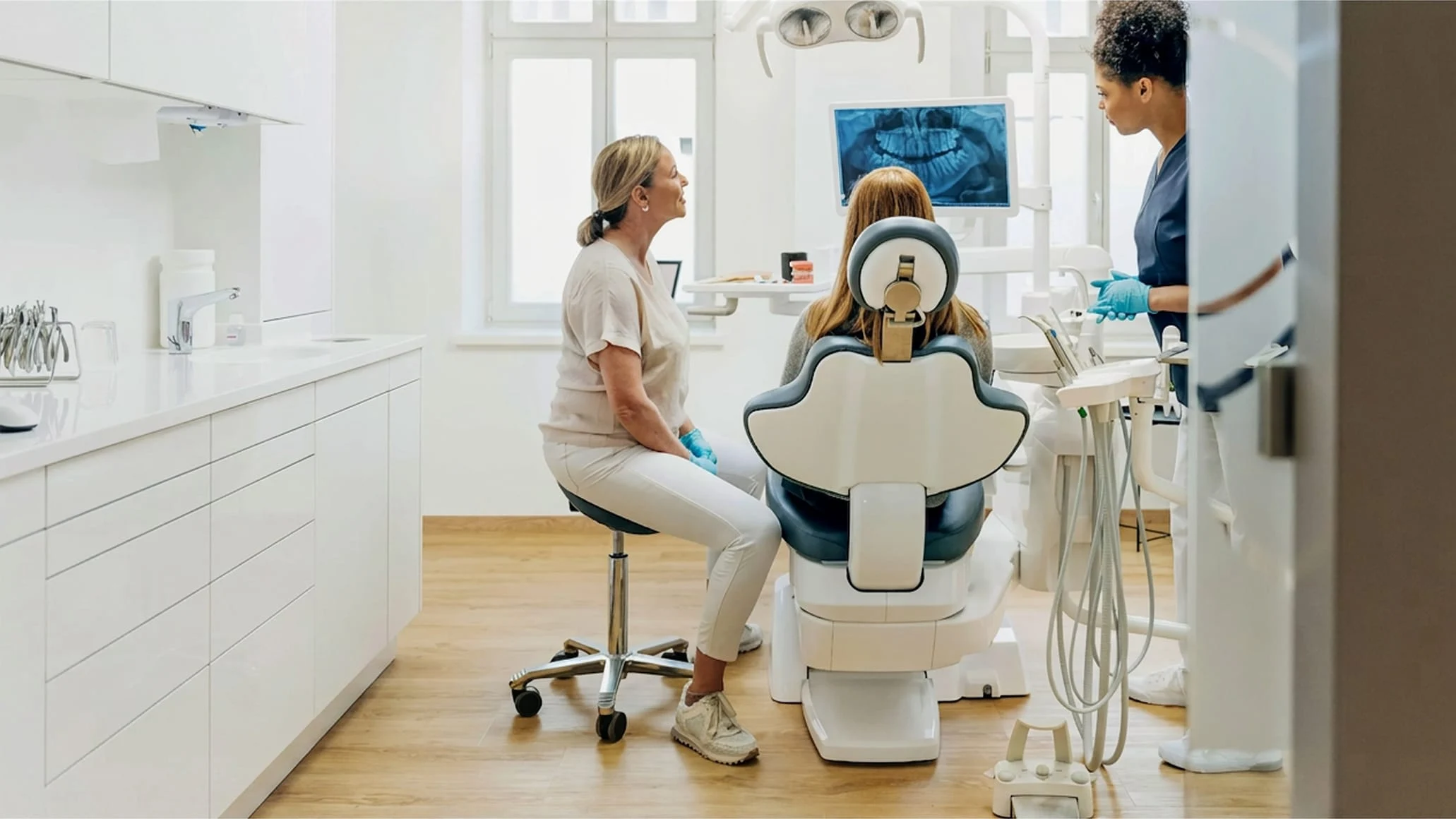 A customer receiving dental treatment from a dentist using an Adyen payment terminal in a clinic.