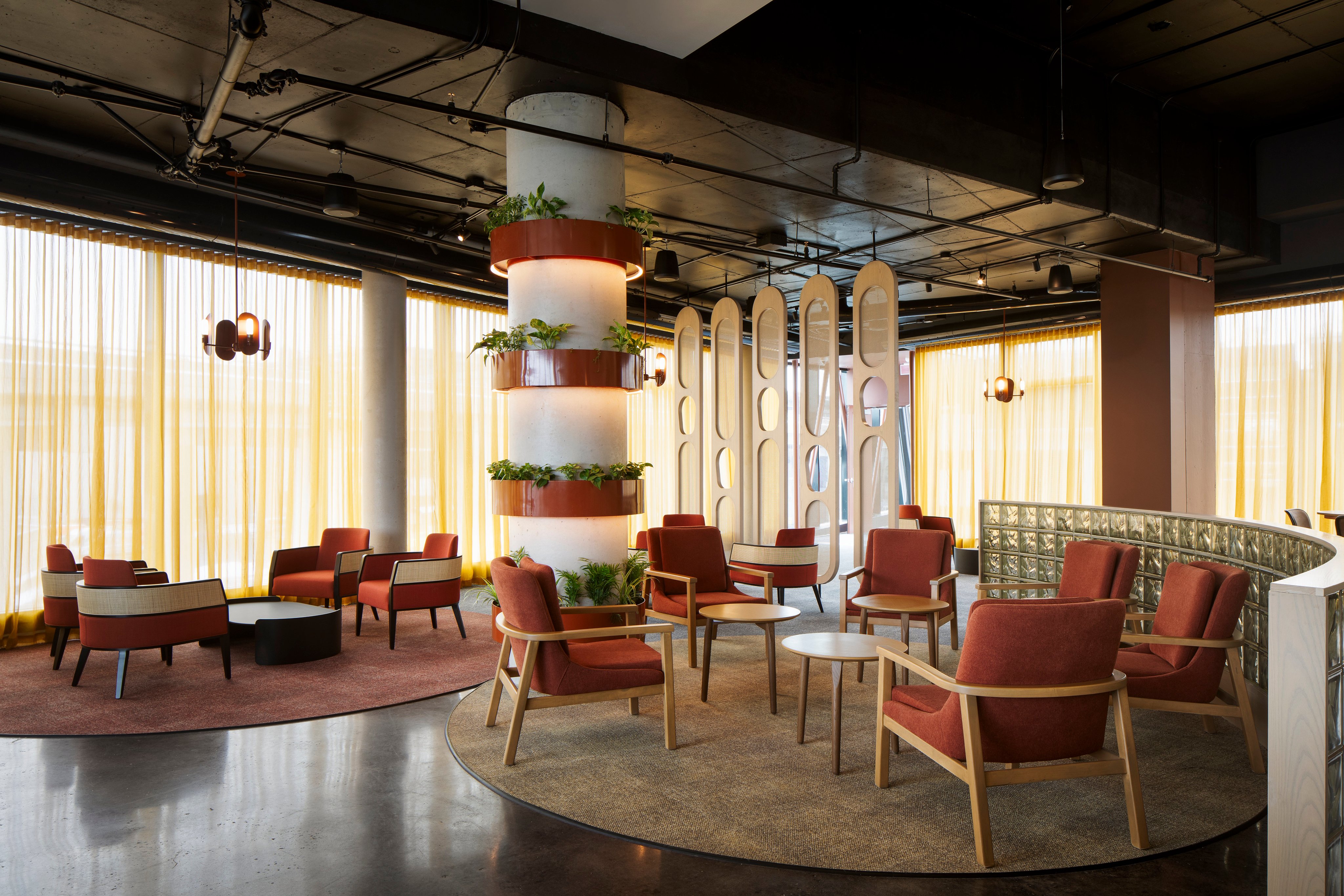 Modern lounge area with seating and decorative plants in an upscale business setting