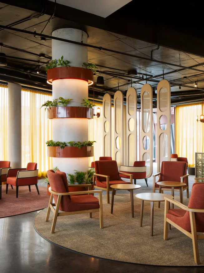 Modern lounge area with seating and decorative plants in an upscale business setting