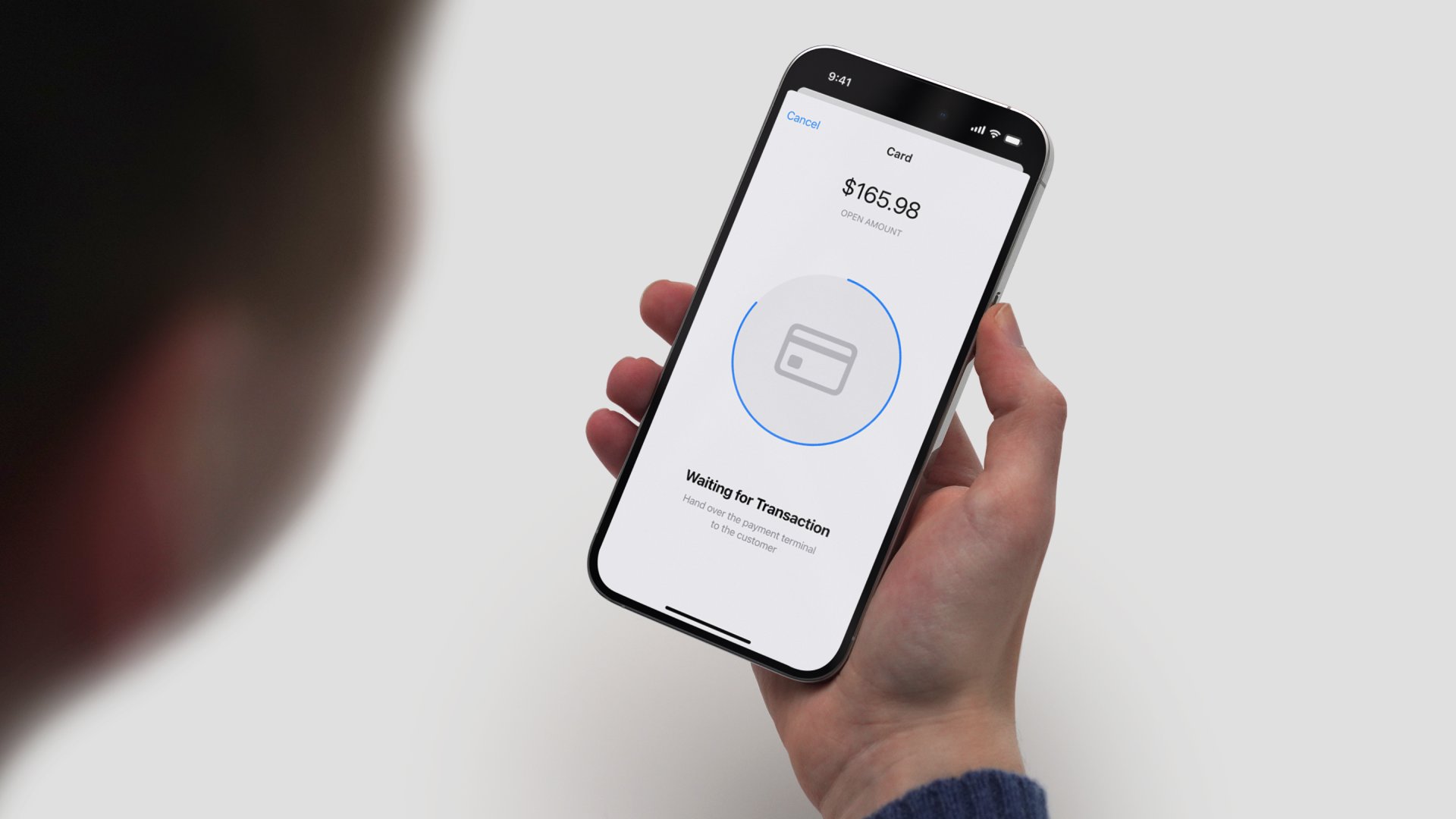 A customer making a payment using a mobile payment app on a smartphone with Adyen payment confirmation.