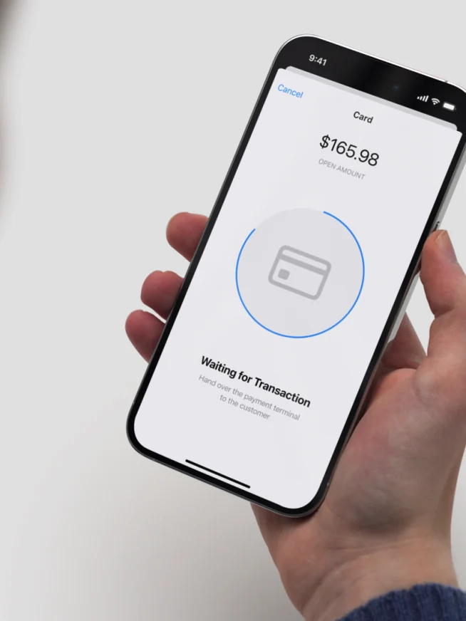 A customer making a payment using a mobile payment app on a smartphone with Adyen payment confirmation.