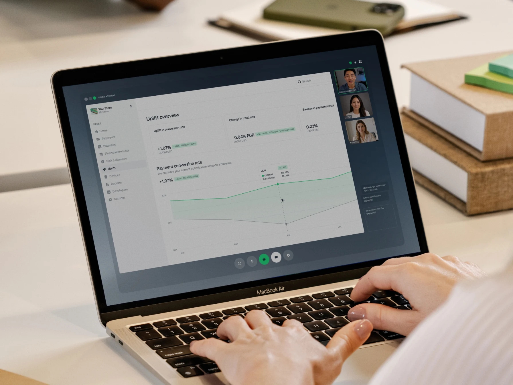 Adyen team members review transaction analytics on a laptop during a remote meeting.