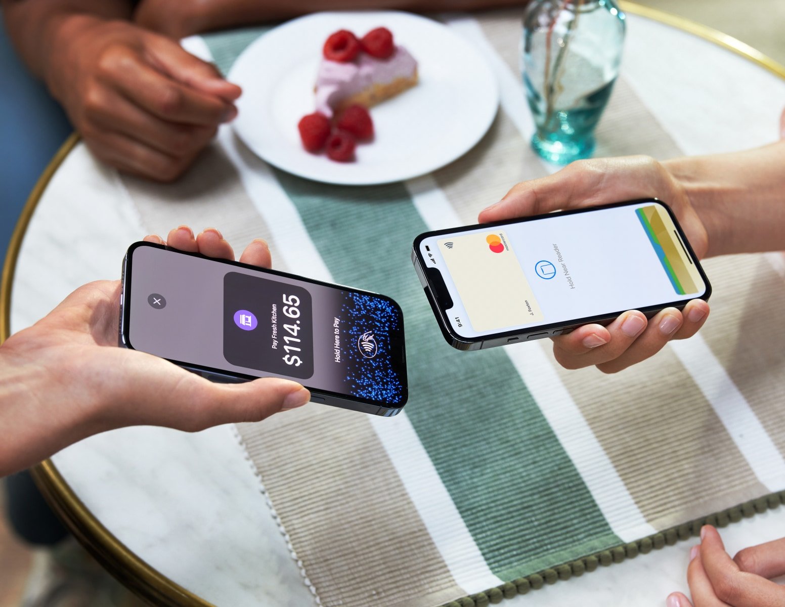 Two people tapping smartphones to process a contactless payment with Adyen app displaying the amount.