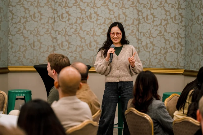 Adyen team members in a meeting, with a presenter speaking to colleagues.