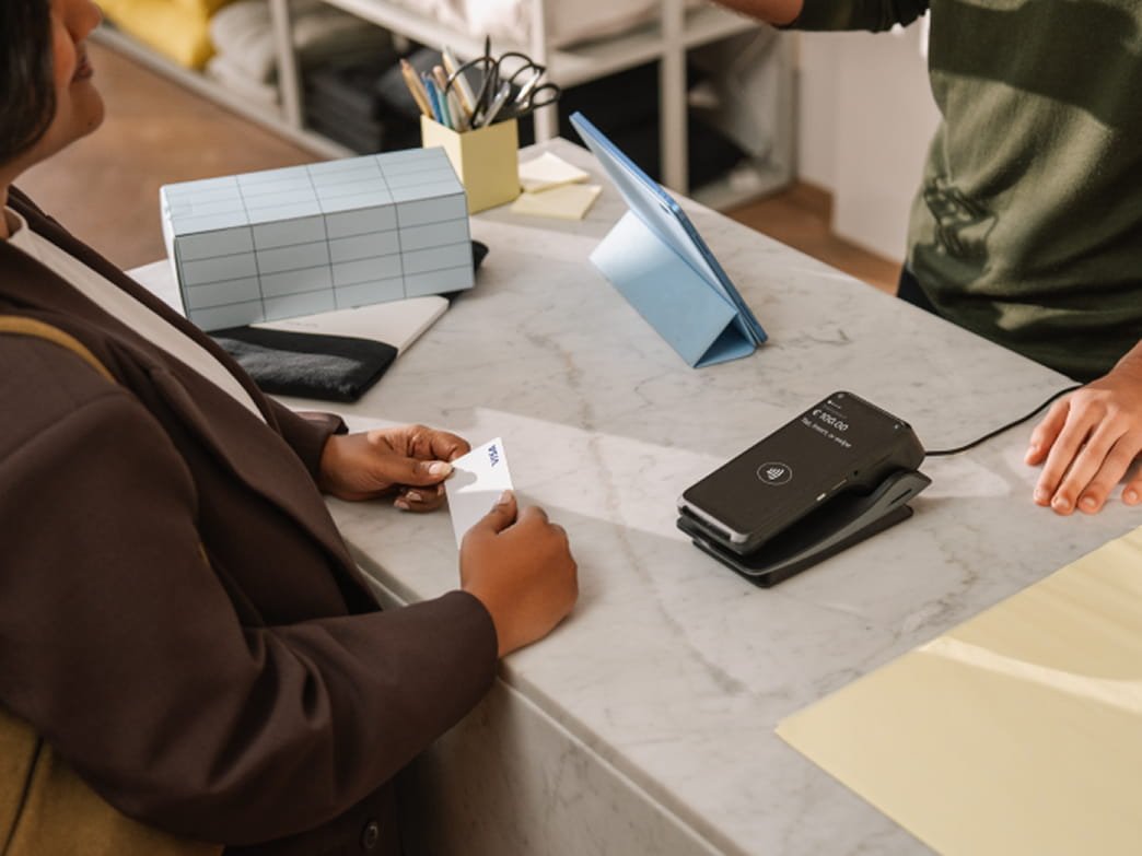 Customer making a payment at a POS terminal with an Adyen card reader.