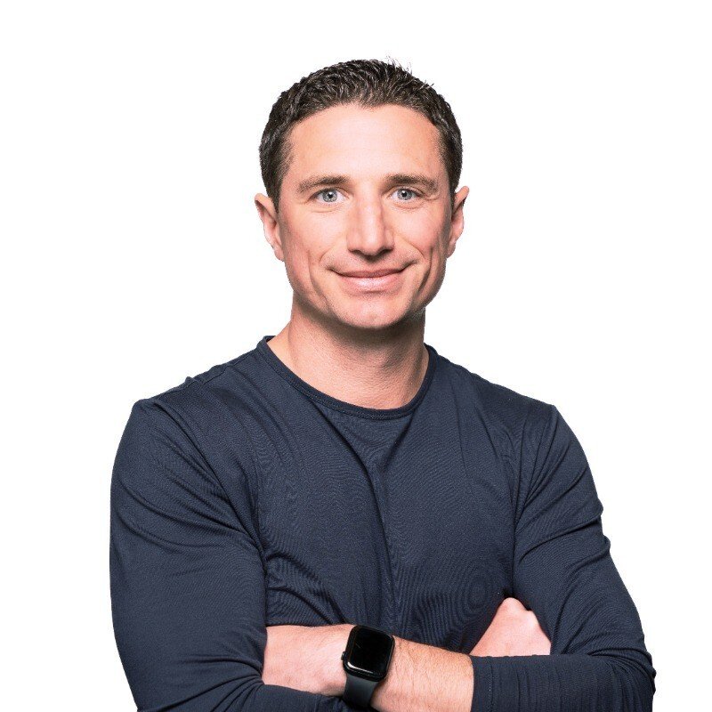 Adyen team member with crossed arms wearing a smartwatch in the Adyen office