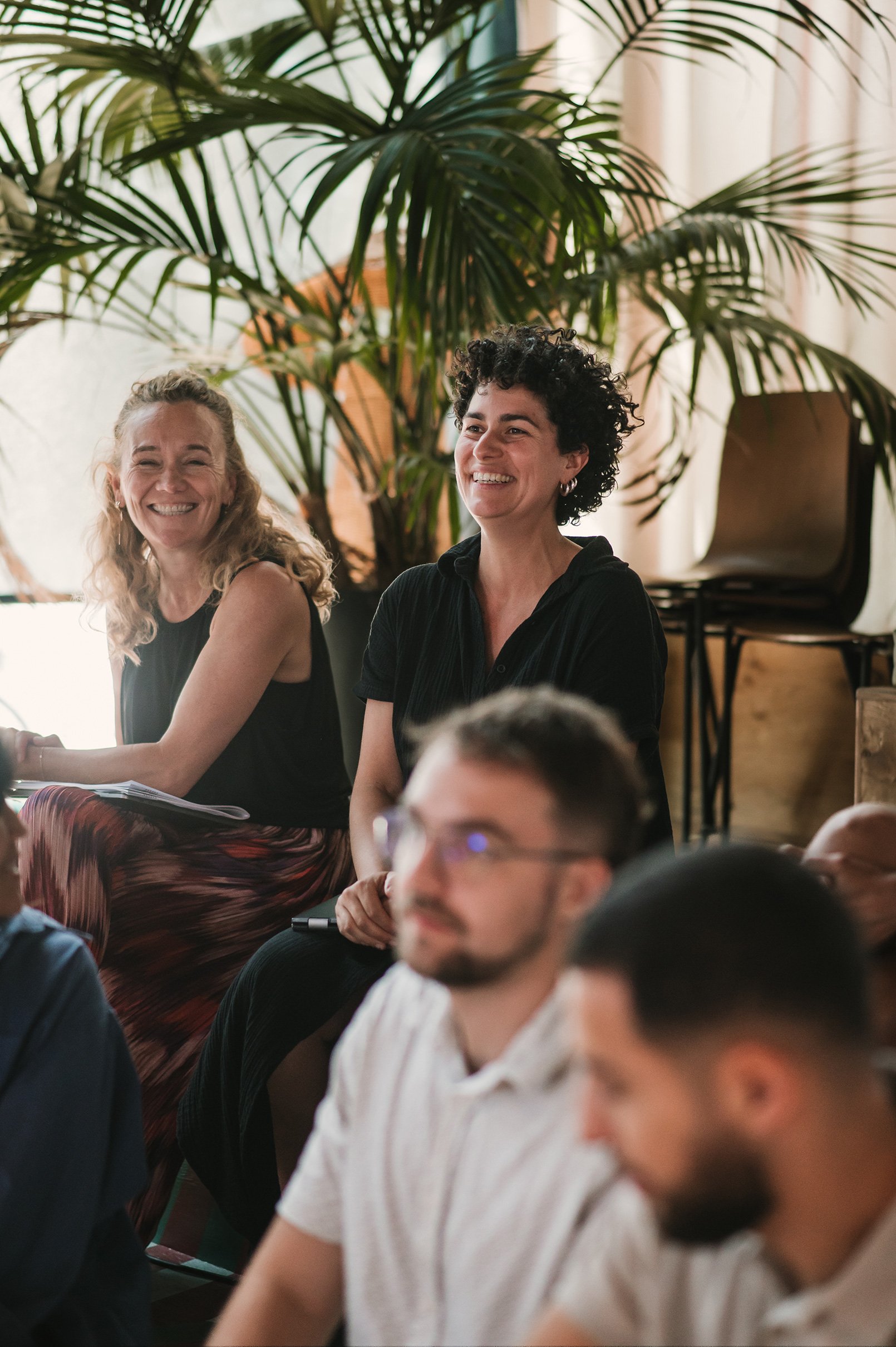 Adyen team members laughing and engaging at a meeting in a bright office setting