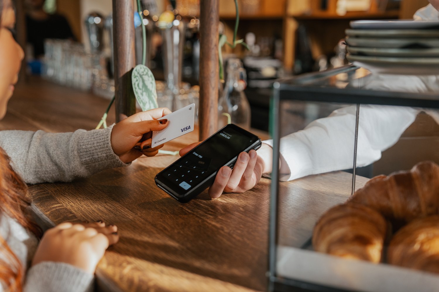 Customer making a contactless payment at a point-of-sale using an Adyen terminal