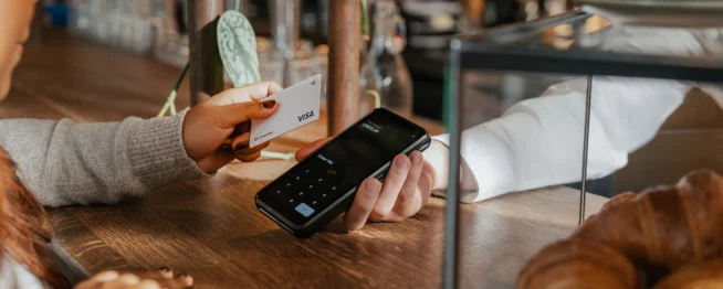 Customer making a contactless payment at a point-of-sale using an Adyen terminal