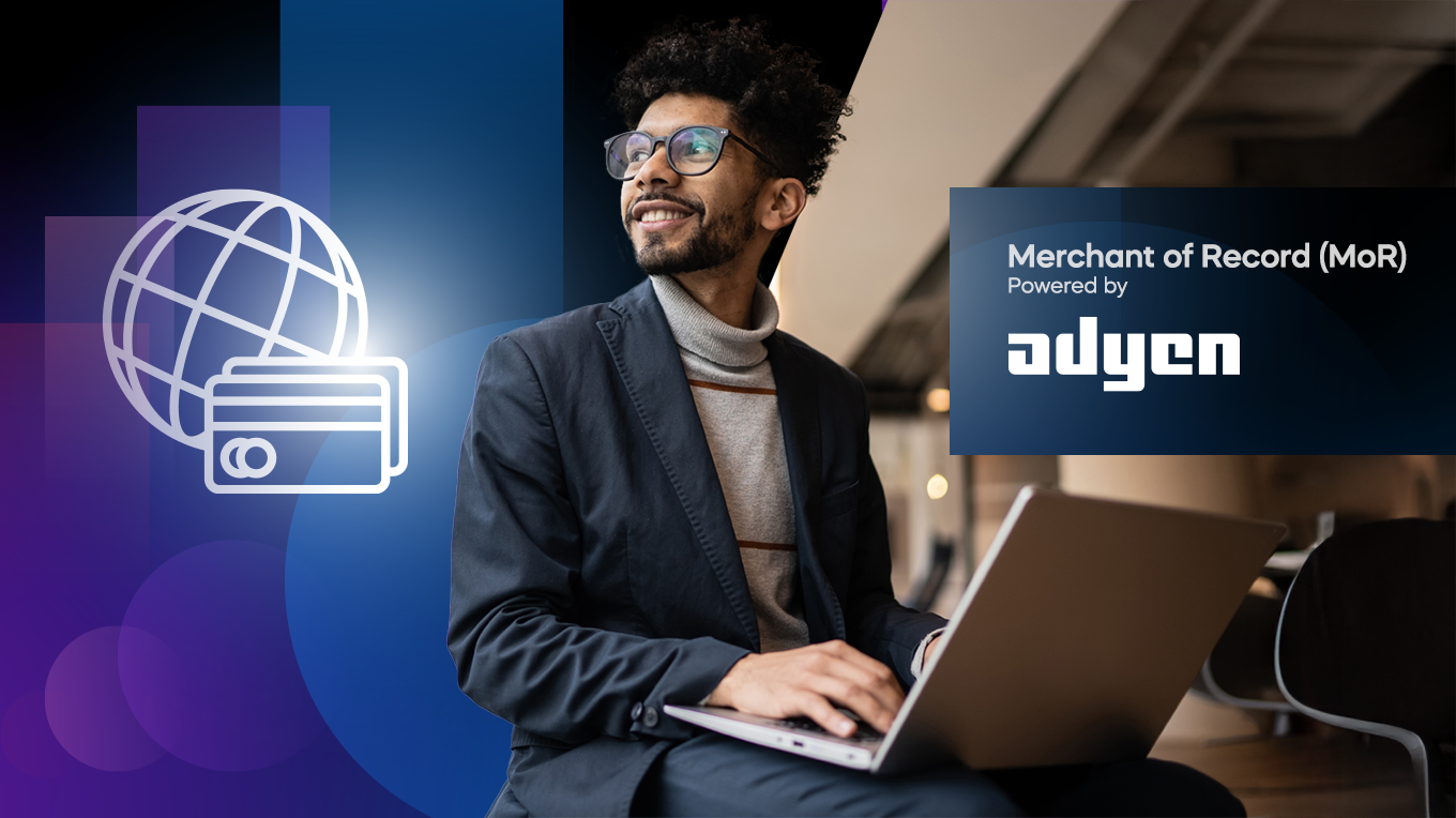Adyen team member using a laptop at the office with Merchants Record logo visible