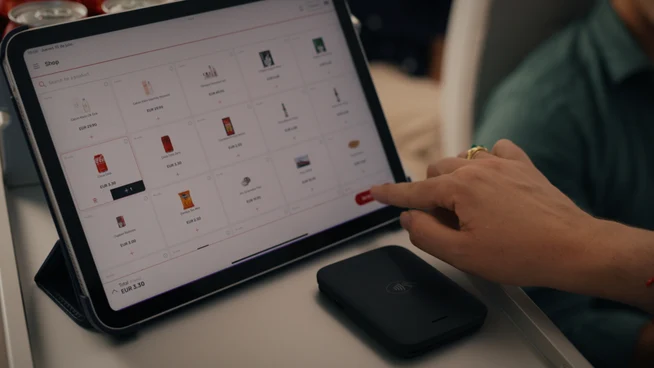 Adyen team member using a tablet with payment options on screen in the office