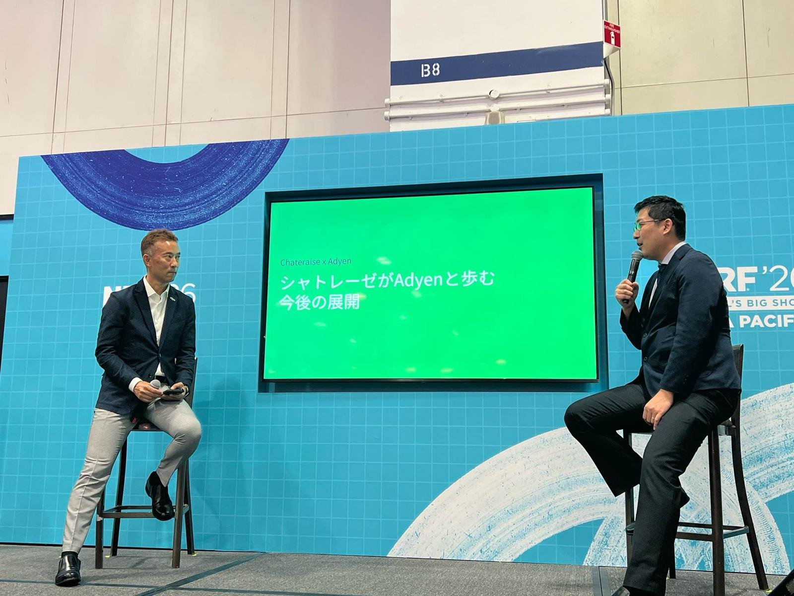 Adyen team members discussing during a presentation at the Adyen event.