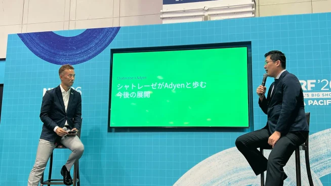 Adyen team members discussing during a presentation at the Adyen event.