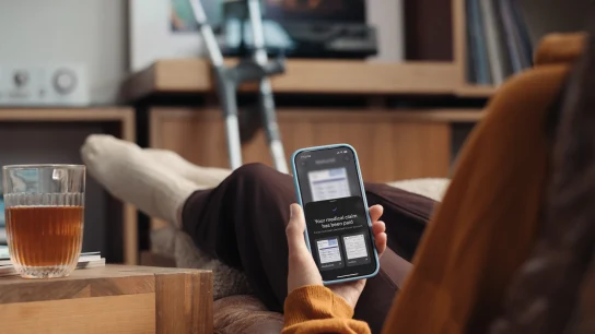 Person with broken leg getting their medical claim on the insurance app