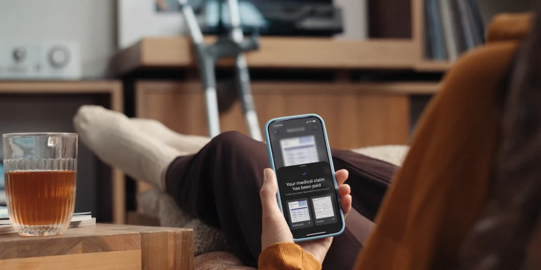 Person with broken leg getting their medical claim on the insurance app