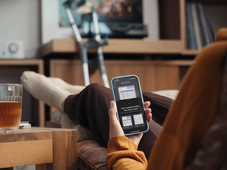Person with broken leg getting their medical claim on the insurance app
