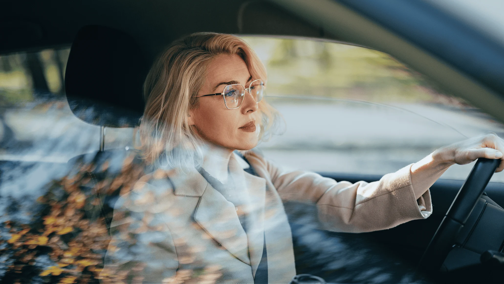 A woman driving a car, possibly using a payment terminal, with payment activity provided by Adyen.
