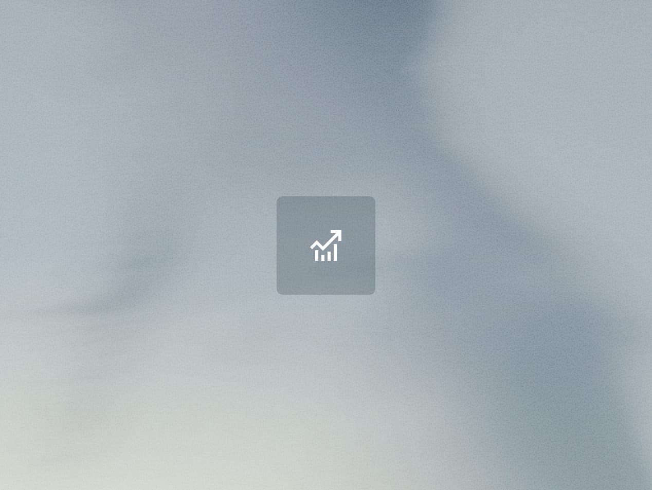 Blurry image with a chart icon, possibly indicating growth or analytics, without clear details or context.