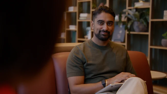 Adyen team member smiling during a meeting in the Adyen office environment