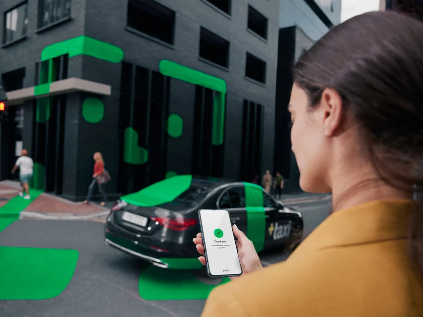 Woman viewing ride hailing app on phone