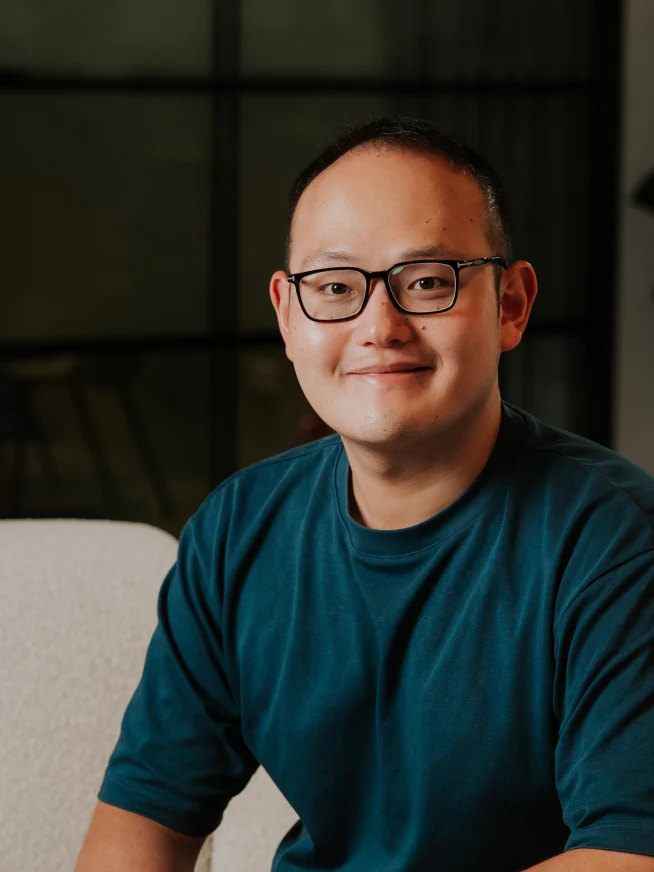 Adyen team member sitting on a sofa in the company office setting