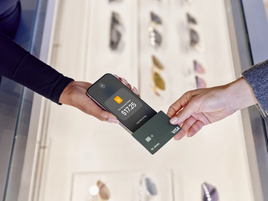 Customer making a contactless payment using an Adyen card and payment app.