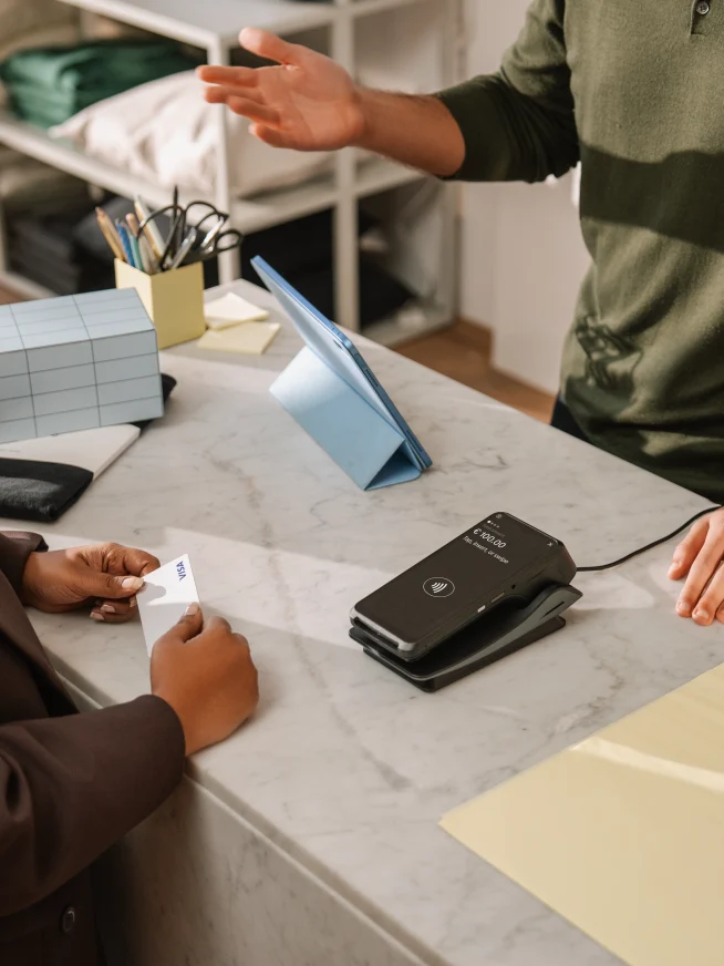 Woman paying with card at counter