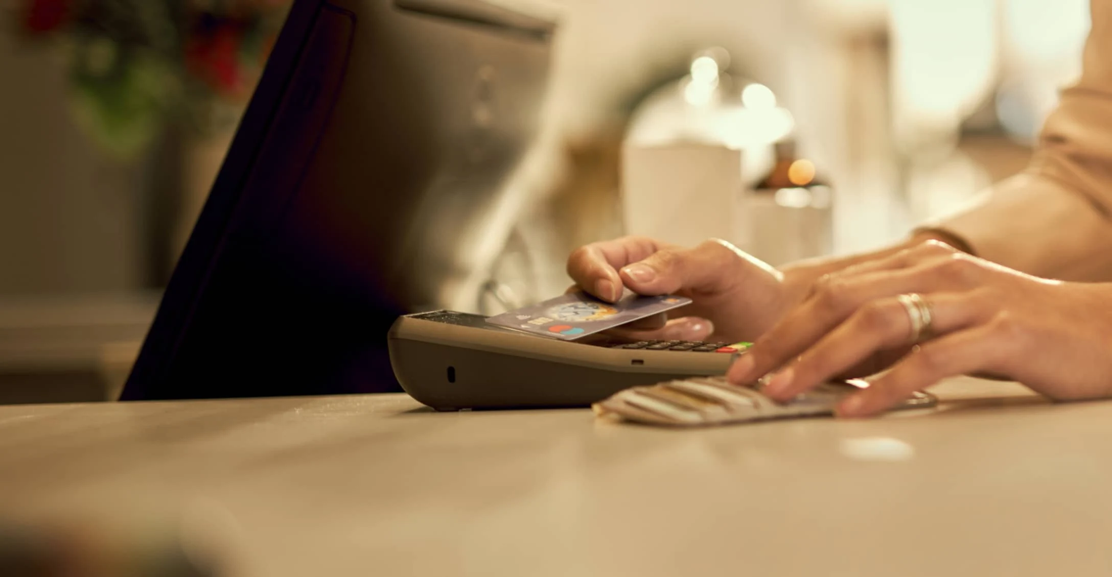 Close-up of a contactless payment being processed with a card and a POS terminal.