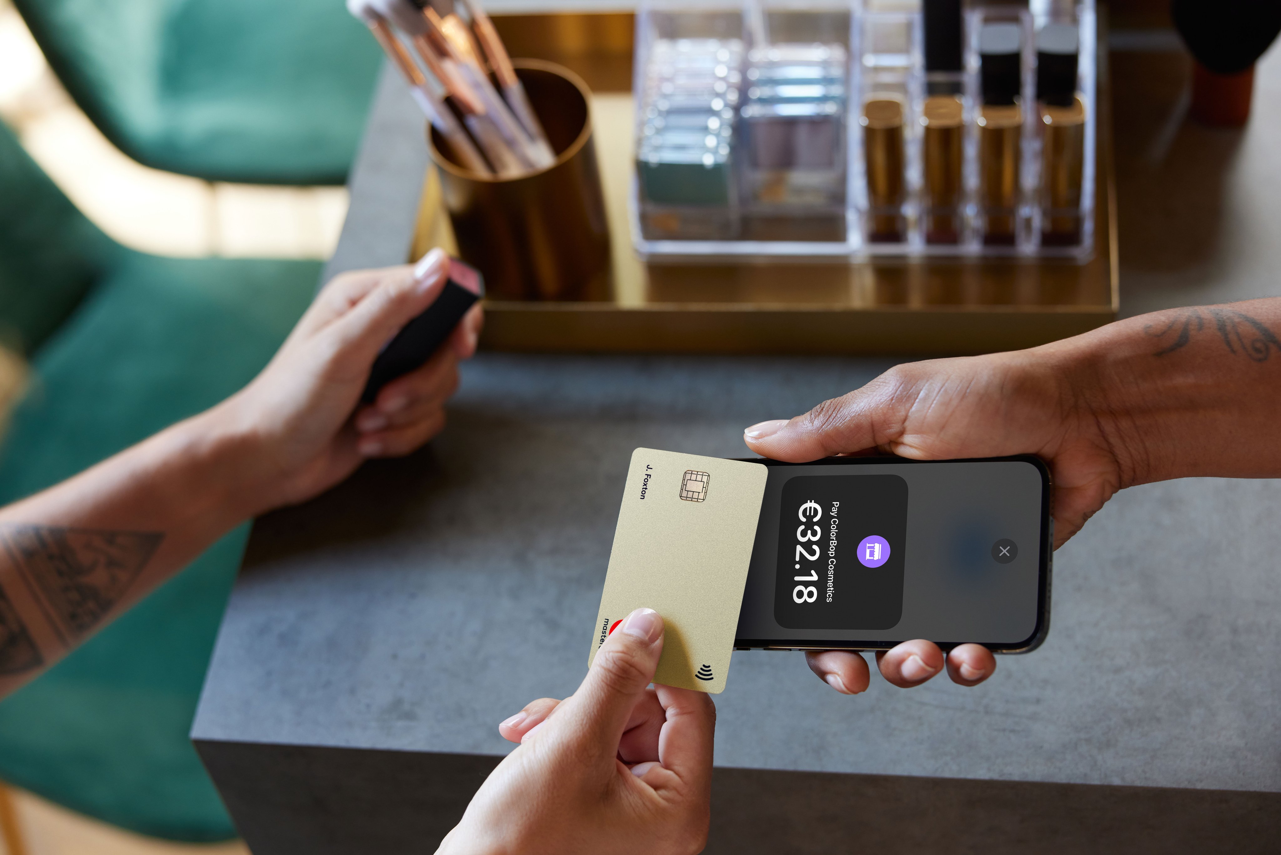 Shop owner and customer using Tap to pay on iPhone with creditcard