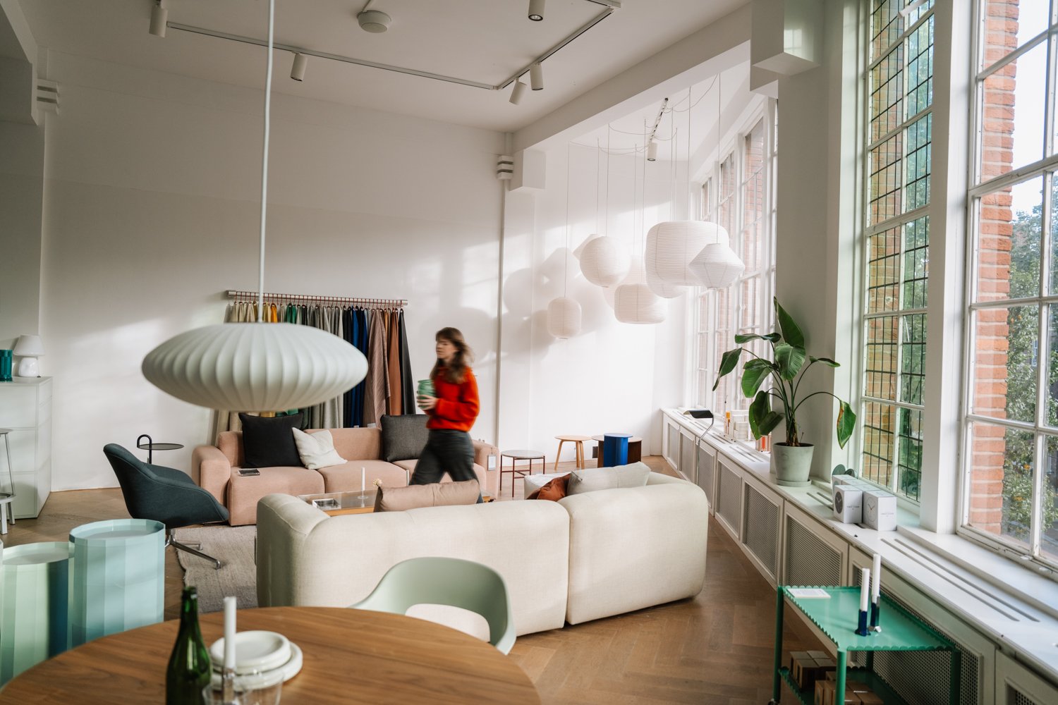 Bright modern office with Adyen employees working and relaxing in a well-lit space