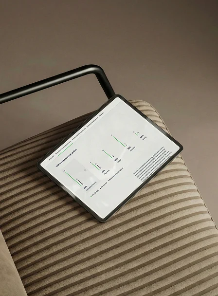 Smartphone displaying a financial dashboard resting on a striped surface.