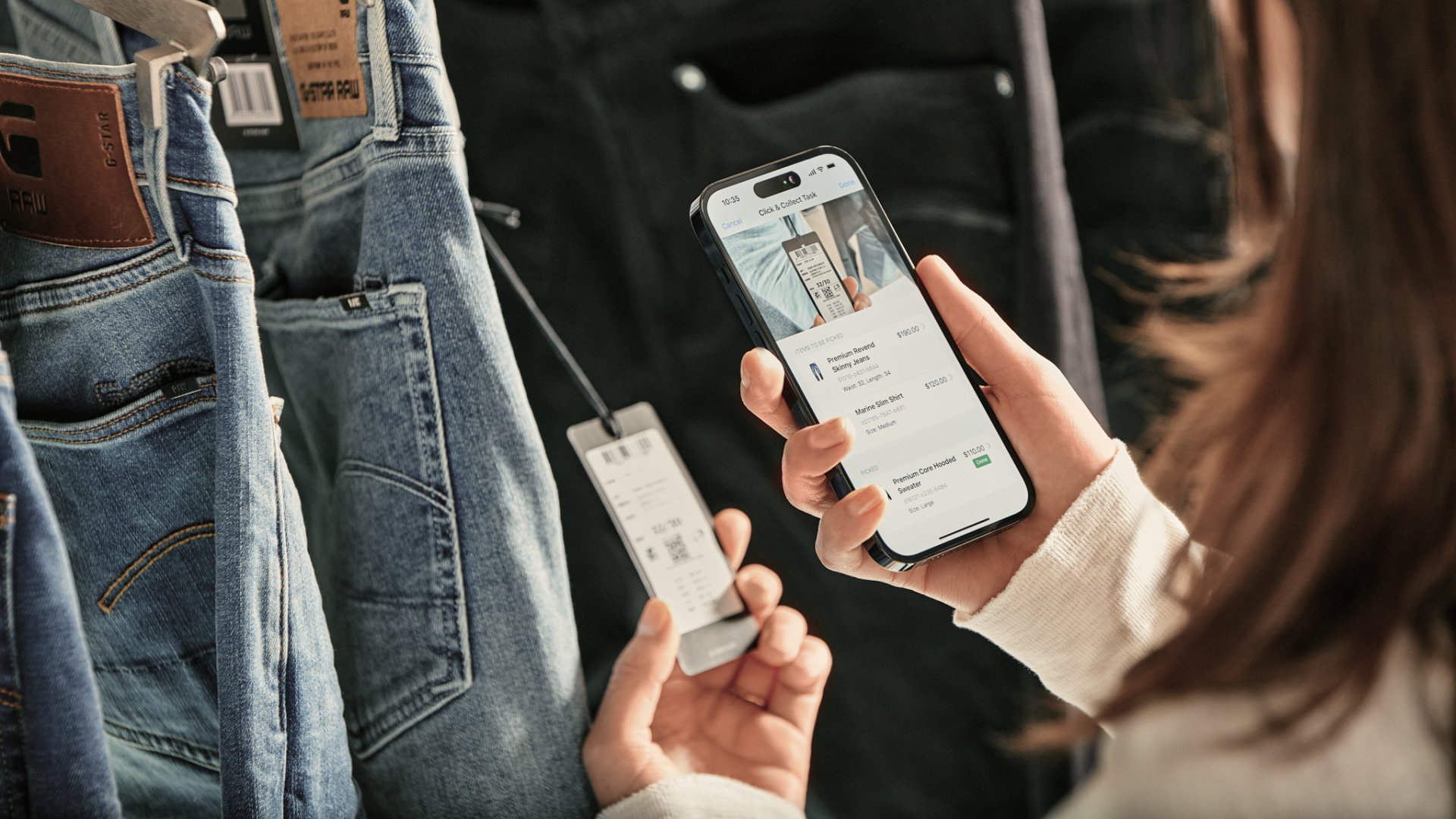 A customer using a mobile device to make a payment with an Adyen terminal.