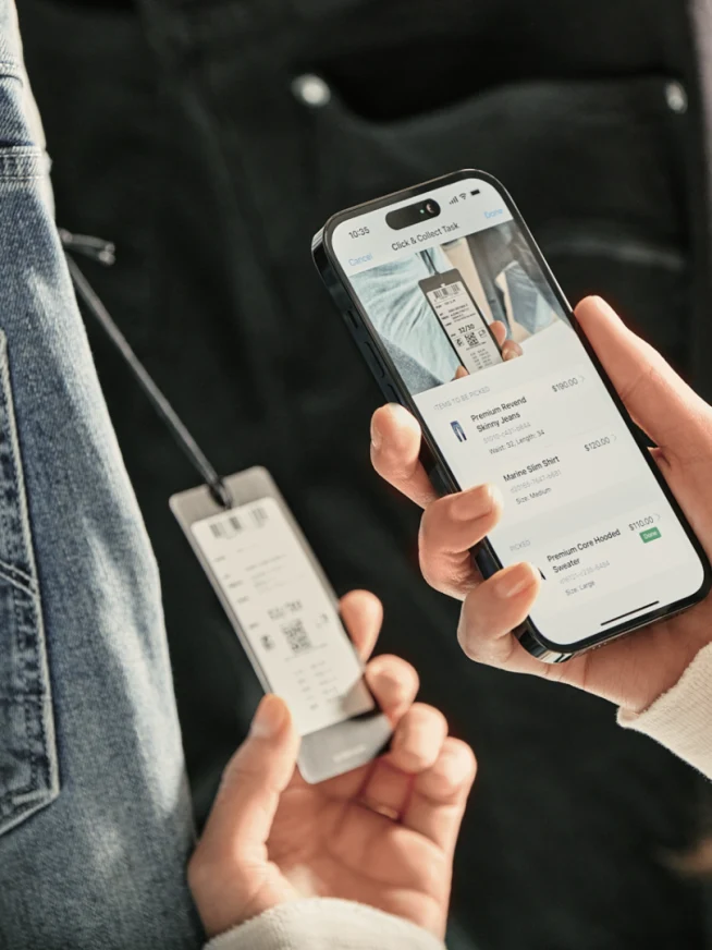 A customer using a mobile device to make a payment with an Adyen terminal.
