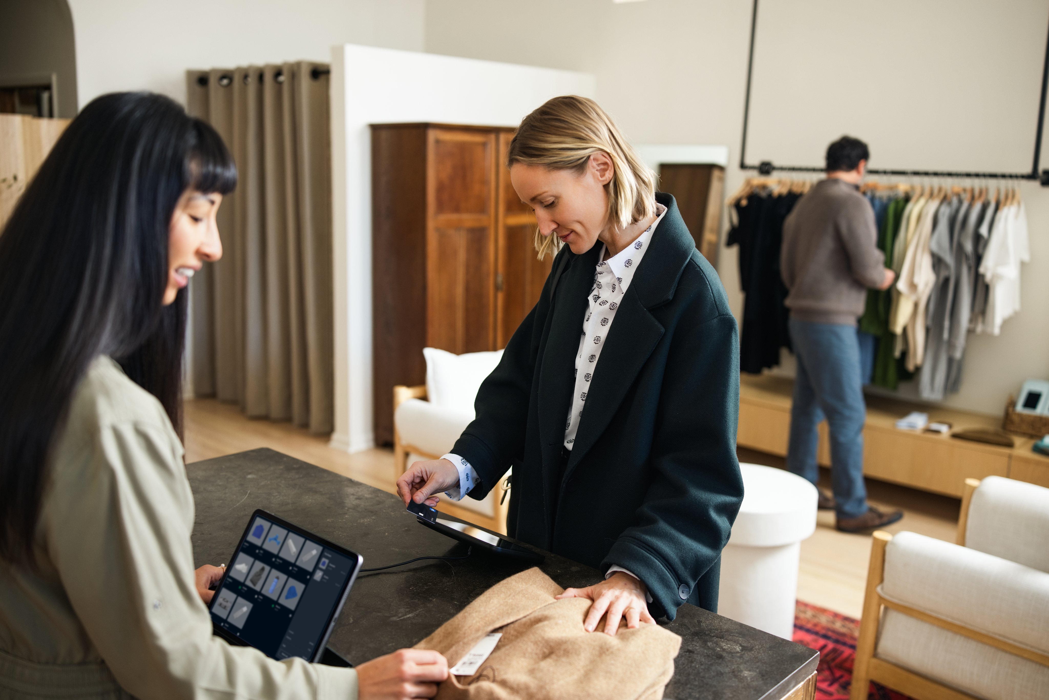 Adyen employees in the Adyen office assisting a customer with a payment transaction.
