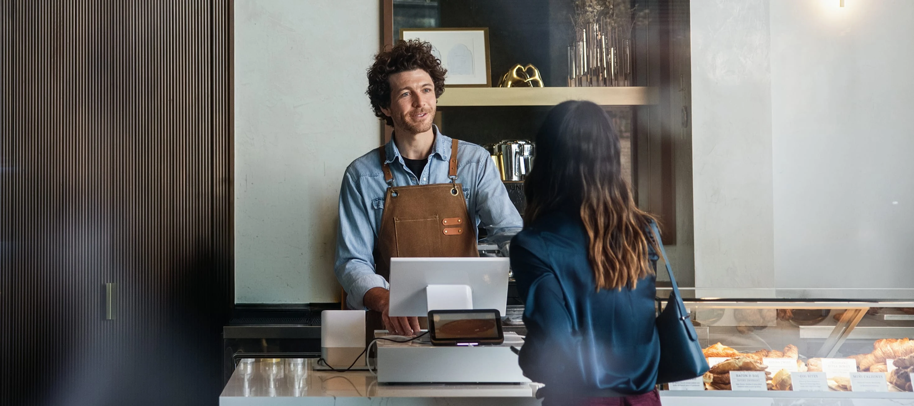 Adyen team members at a terminal in the office engaged in transaction processing.