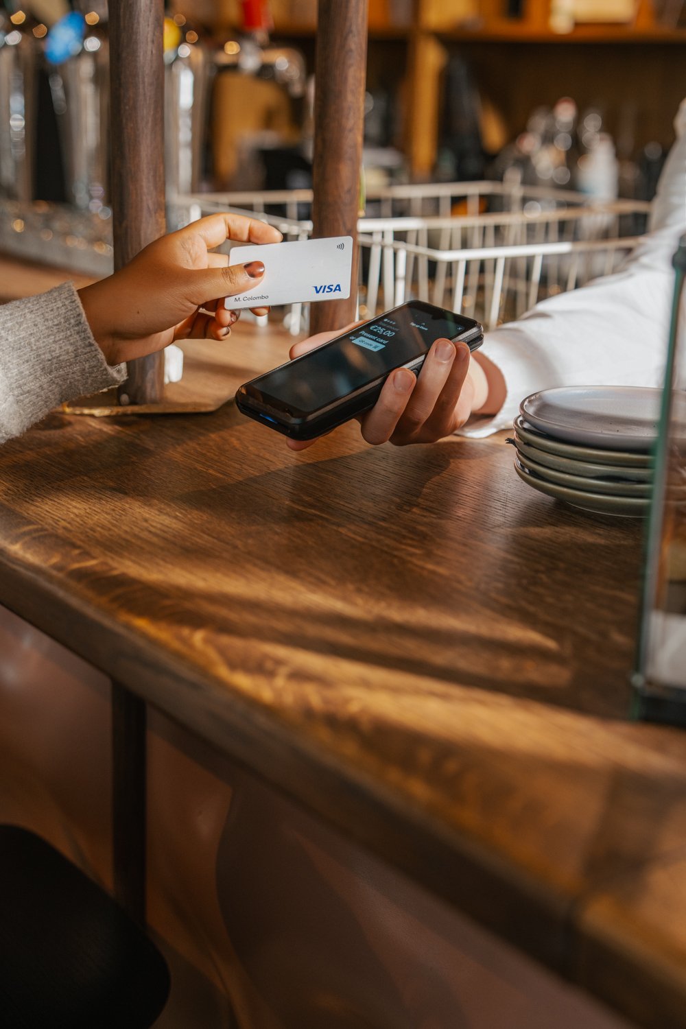 Business customer using a card and smartphone for payment in a retail environment with Adyen terminal