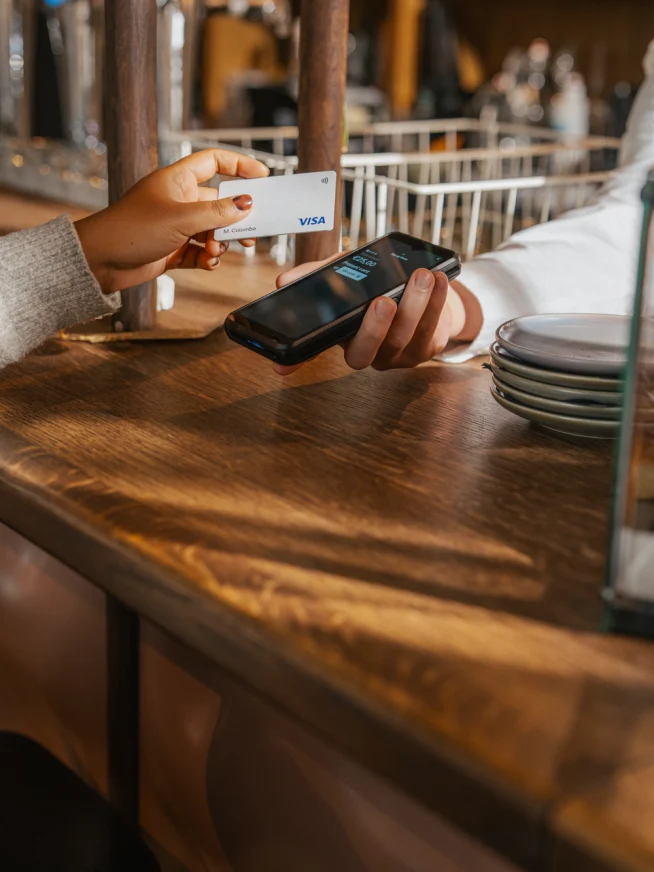 Business customer using a card and smartphone for payment in a retail environment with Adyen terminal