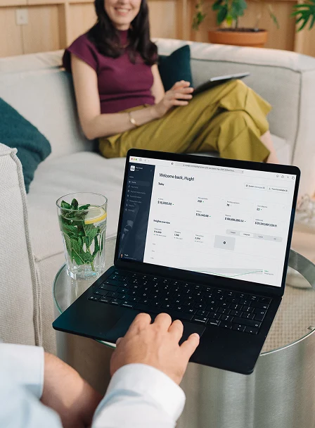 A business owner making a payment using an Adyen-powered laptop in a modern setting
