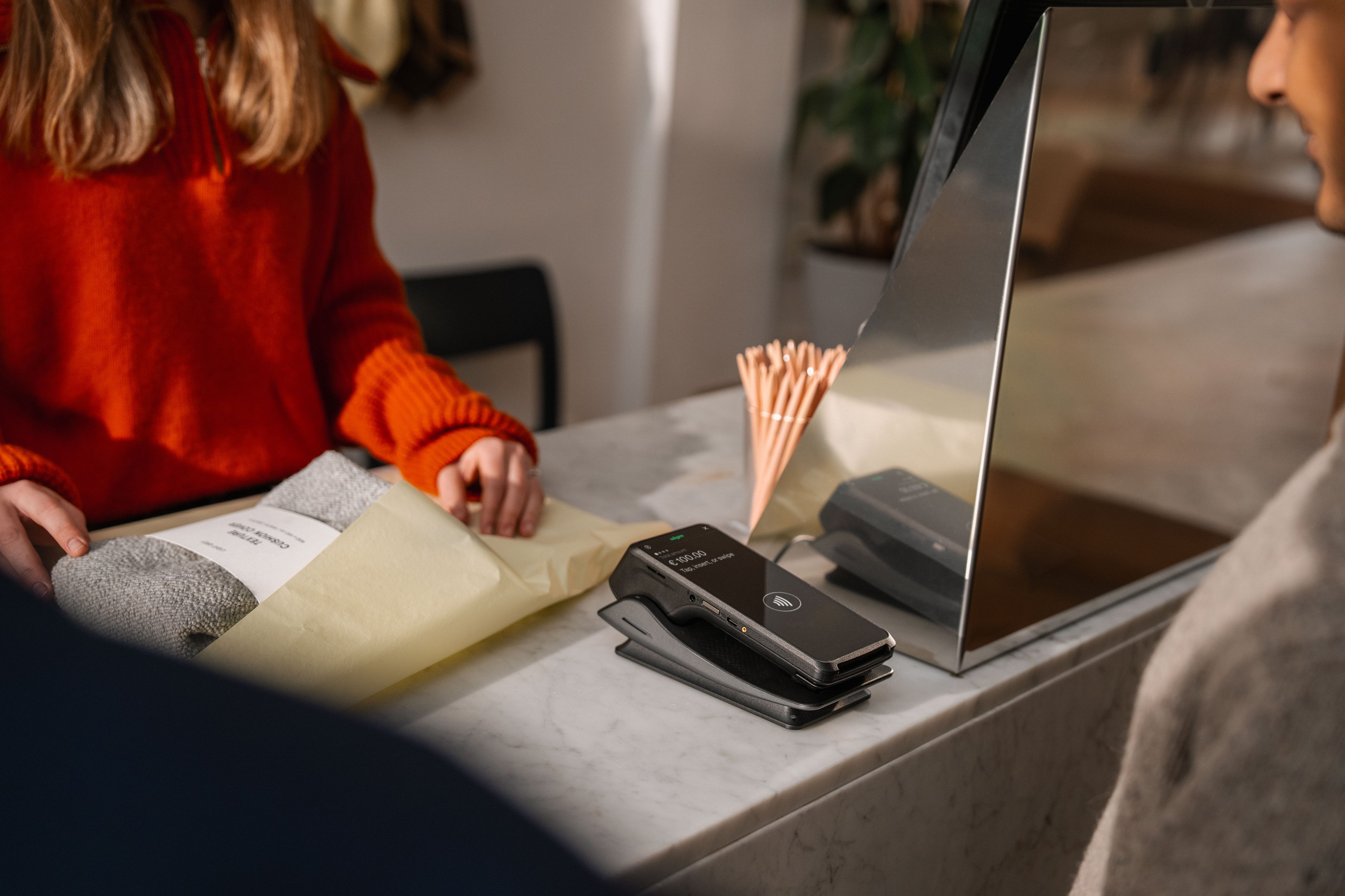 Customer making a payment at an Adyen terminal in a retail setting