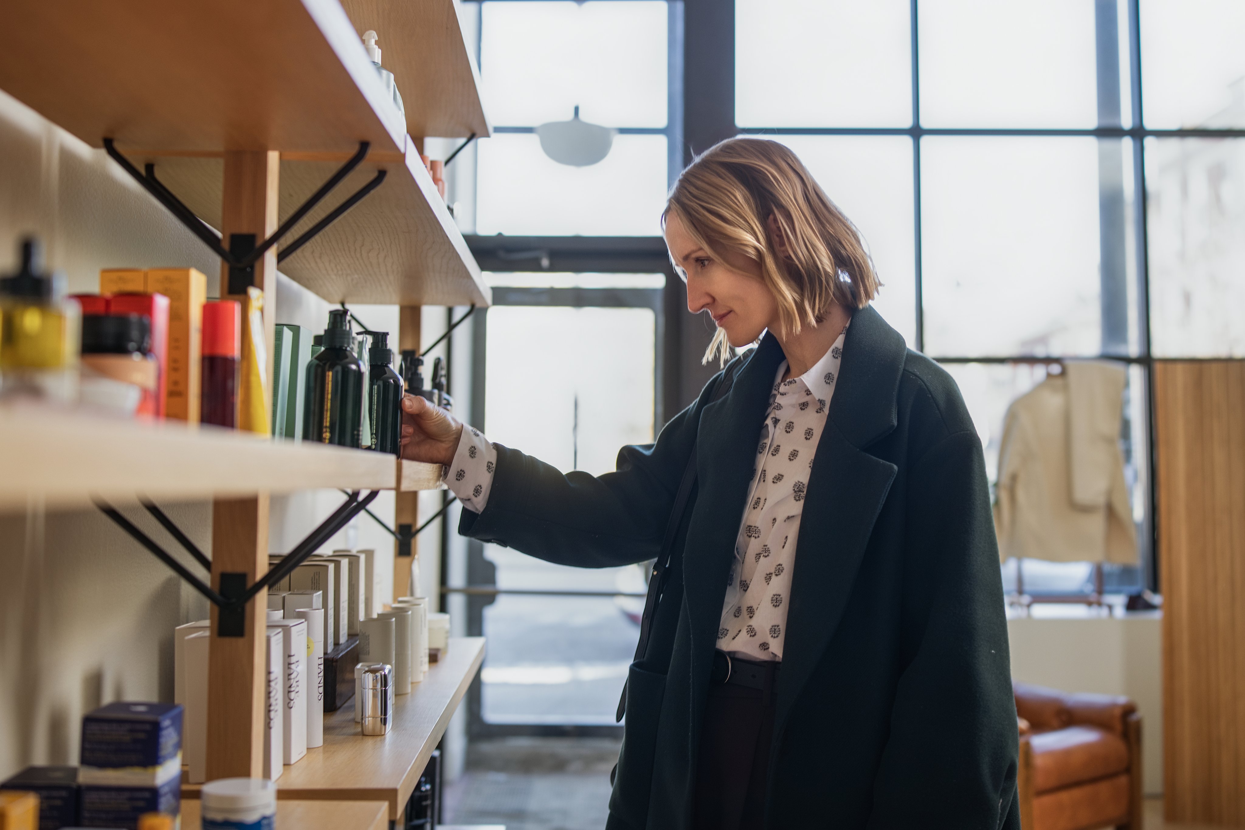 Adyen employees in the Adyen office browsing products on a shelf.