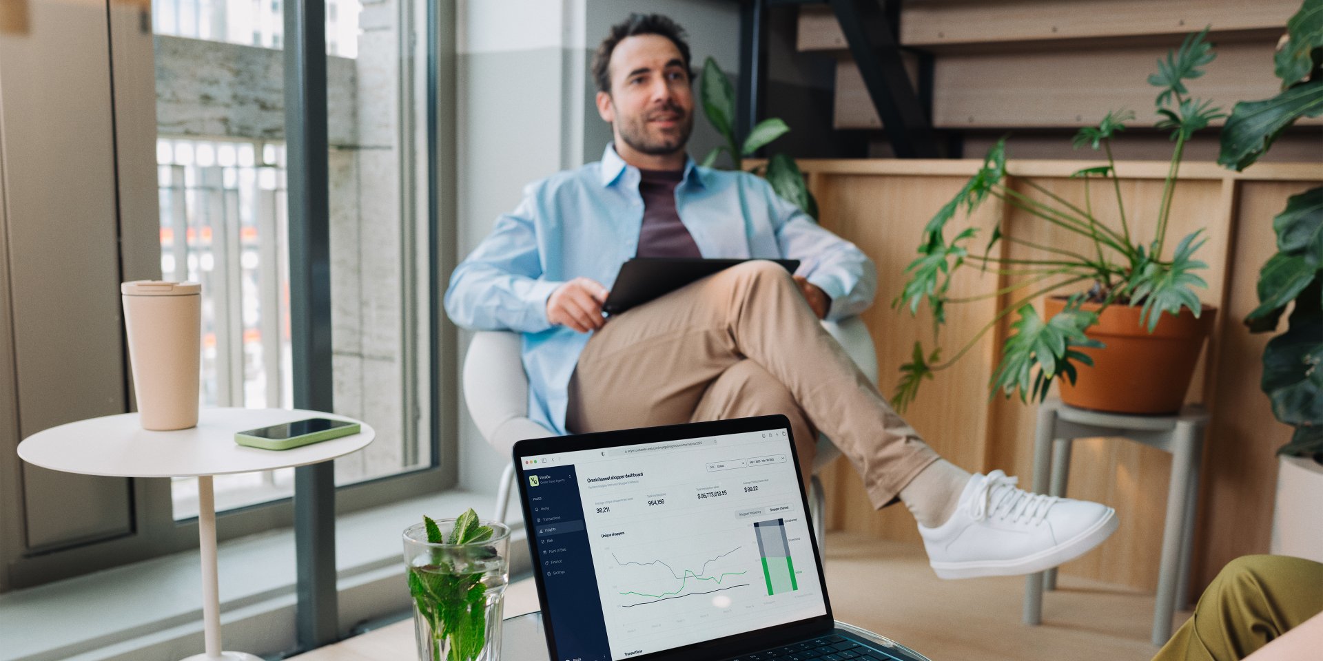 Adyen team members analyzing data on a laptop in a modern office setting