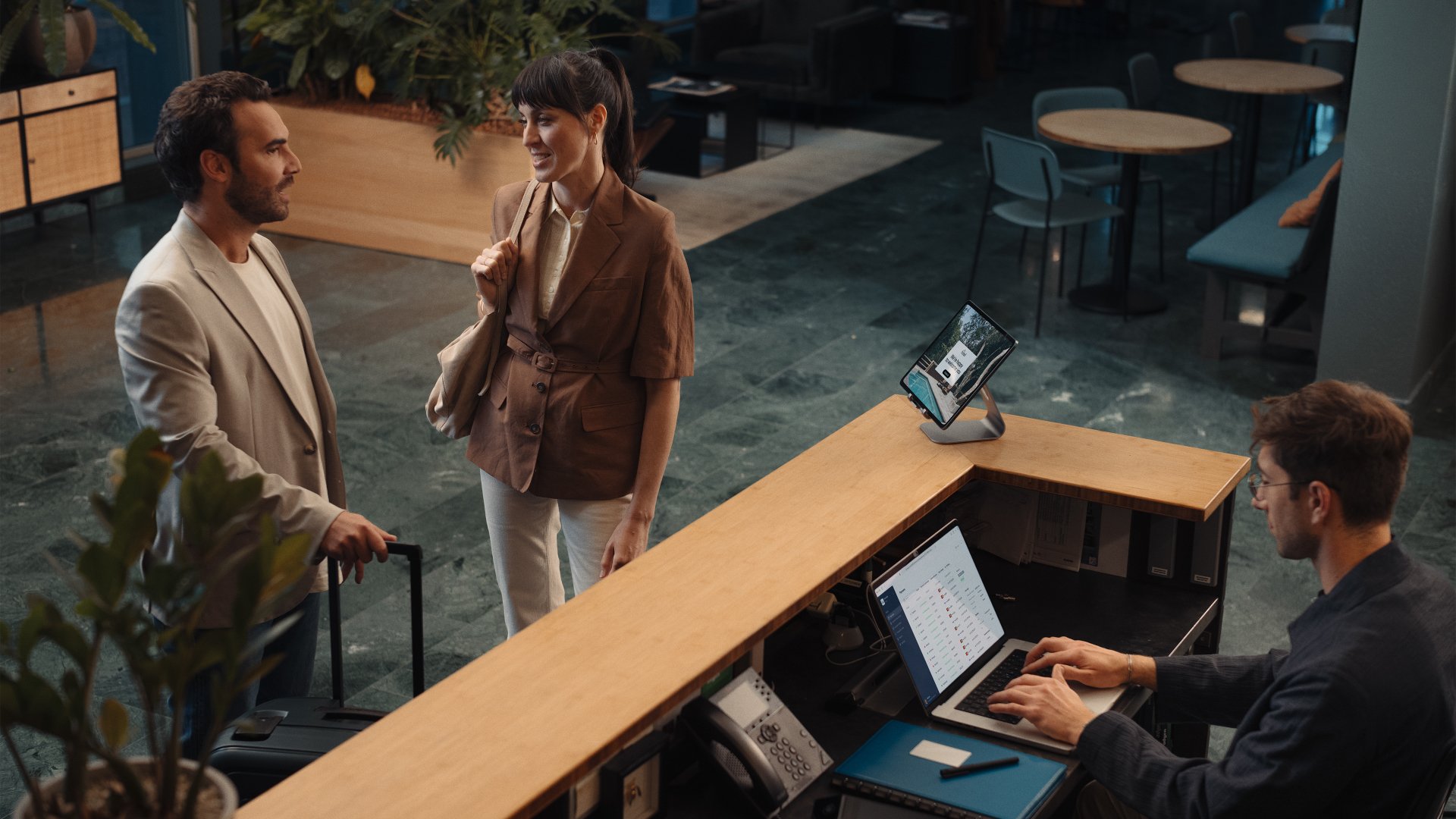 Adyen employees in the office interacting with customers at the reception desk.