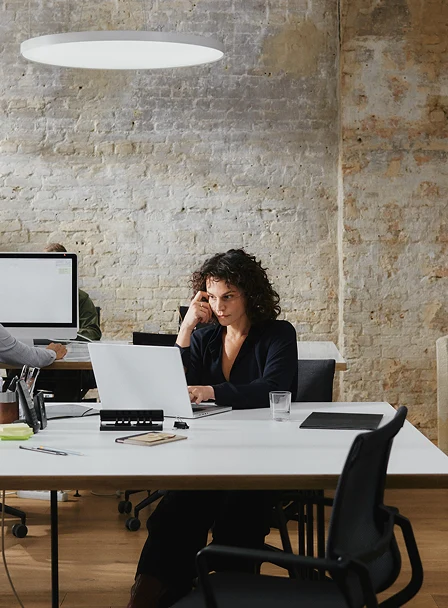 Adyen employees working in an office environment with computers and office supplies