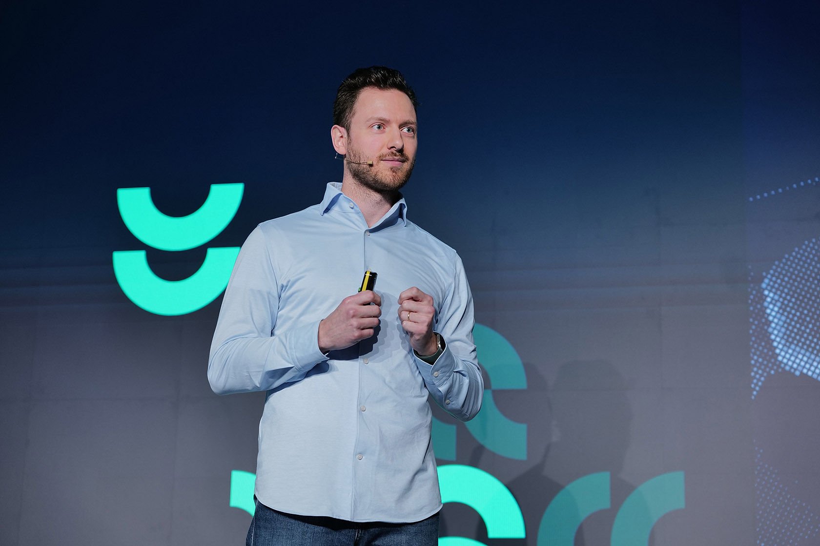 Adyen team member in a light blue shirt prepares to present or demonstrate in the Adyen office.